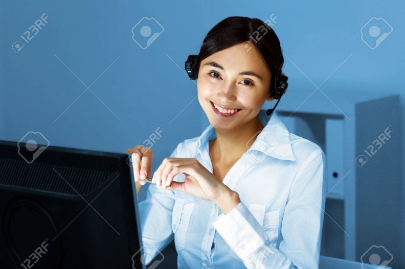11987372-young-woman-in-business-wear-in-headset-working-with-computer