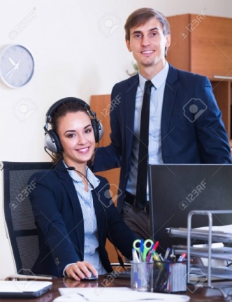 53497258-portrait-of-two-happy-help-line-consultants-at-workplace