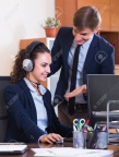 57176674-portrait-of-two-young-help-line-operators-at-workplace