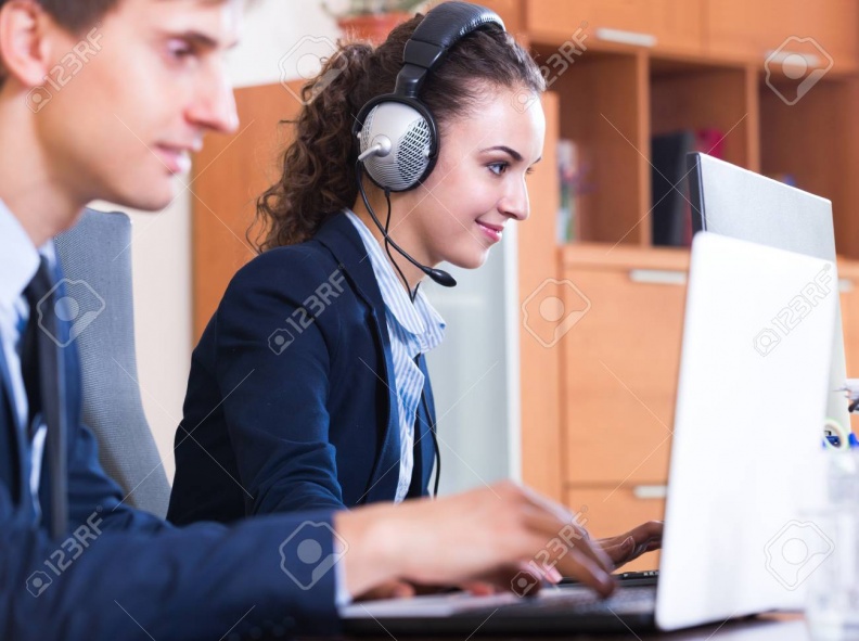 53772749-positive-customer-support-team-working-in-call-centre-focus-on-woman