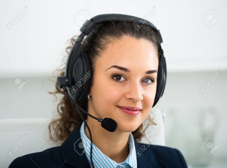 68740286-portrait-of-smiling-young-woman-with-headset-answering-call-in-office.jpg