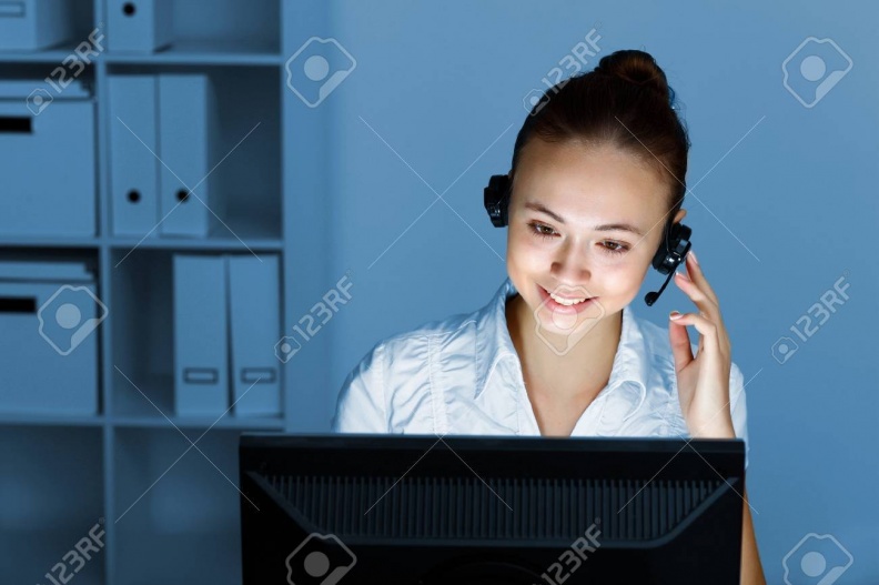 13222912-young-woman-in-business-wear-in-headset-working-with-computer
