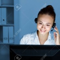 13222912-young-woman-in-business-wear-in-headset-working-with-computer