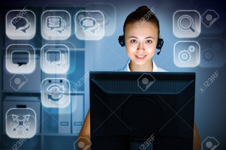 12004700-young-woman-in-business-wear-in-headset-working-with-computer.jpg