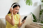 asian-smiling-girl-student-wear-wireless-headphone-study-online-with-skype-teacher-coffee-shop 61243-817
