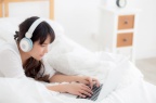 beautiful-young-asia-woman-lying-bedroom-using-laptop 7192-2198