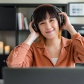 asian-woman-work-with-computer-home-listening-online-class-audio-program-with-headphone 139507-381
