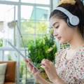 asian-women-wearing-headphones-using-mobile-phone-digital-tablet-listening-music-singing-relaxing-day-home 33718-1773