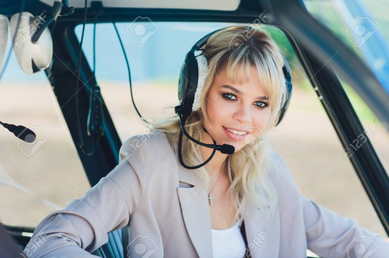 128585818-female-pilot-in-cockpit-of-helicopter-before-take-off-young-woman-helicopter-pilot-