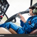 depositphotos 272744570-stock-photo-young-woman-helicopter-pilot-reading