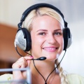 portrait-call-center-operator-smiling-blonde-office-58414259