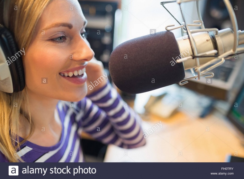 happy-young-female-radio-host-broadcasting-in-studio-FH0TRY.jpg