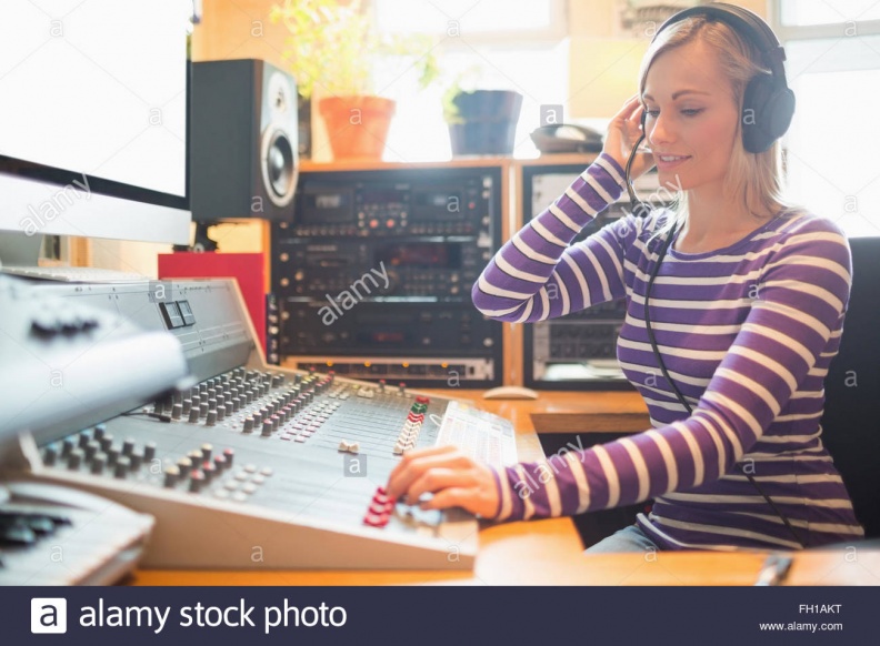 radio-host-wearing-headphones-using-sound-mixer-FH1AKT.jpg