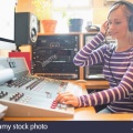 radio-host-wearing-headphones-using-sound-mixer-FH1AKT