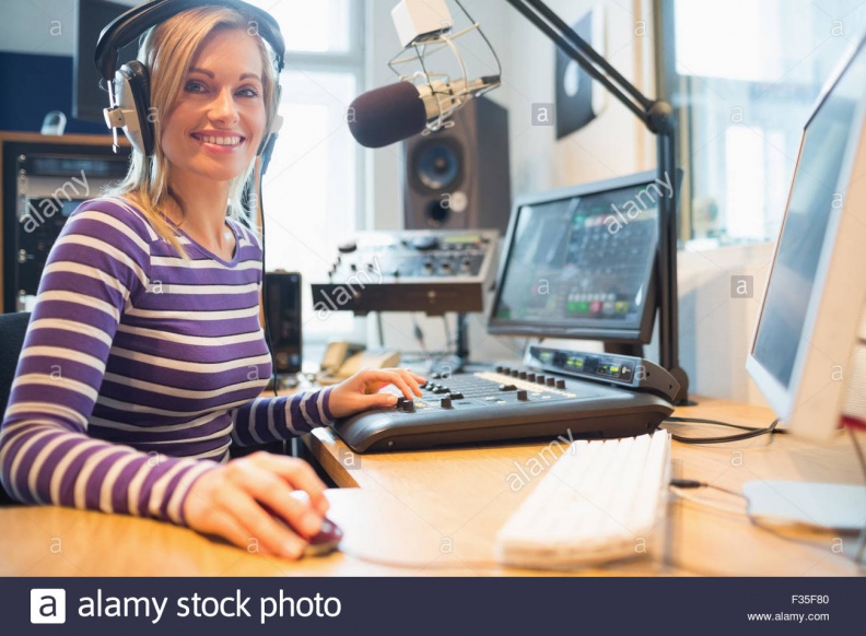 portrait-of-female-radio-host-using-computer-in-studio-F35F80.jpg