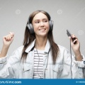 beautiful-young-woman-listening-to-music-headphones-smartphone-lifestyle-people-concept-grey-background-149669384