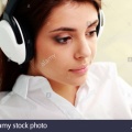 closeup-portrait-of-a-young-beautiful-businesswoman-listening-music-DK6M0F