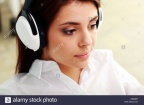 closeup-portrait-of-a-young-beautiful-businesswoman-listening-music-DK6M0F