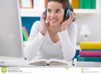 teenager-girl-listening-music-sitting-desk-30941640