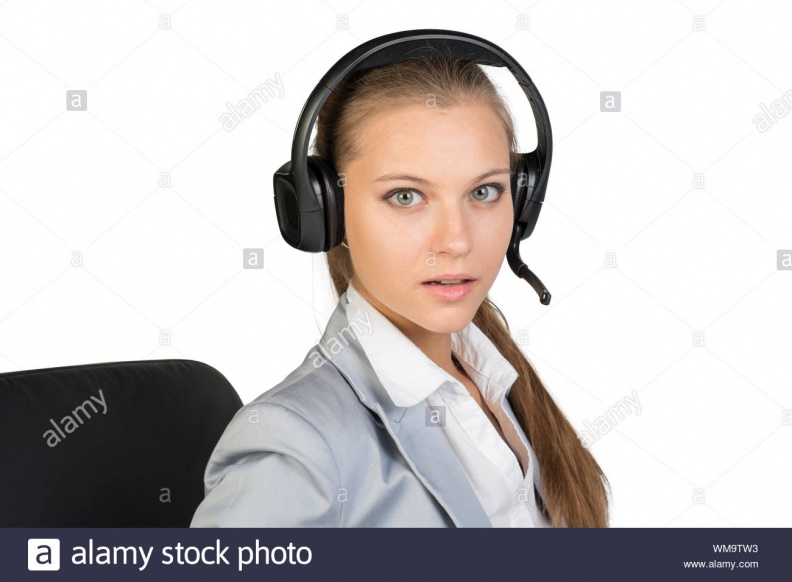 businesswoman-in-headset-sitting-on-chair-her-lips-parted-looking-at-camera-isolated-over-white-background-WM9TW3.jpg