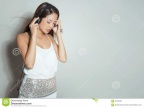 beautiful-young-asian-woman-listening-to-music-headphones-wit-long-hair-enjoying-92163382