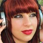 A high resolution photo of an attractive young adult caucasian woman with red hair and bangs wearing oversized vintage headphones, realistic