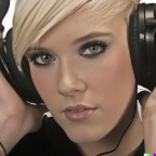 A high resolution photo of an attractive young blonde woman wearing large black vintage headphones, detailed, realistic