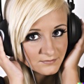 A high resolution photo of an attractive young blonde woman wearing large black vintage headphones, detailed, realistic (7).jpg