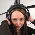 A high resolution photo of an attractive shy young woman wearing a helicopter headset, detailed, realistic (2).jpg
