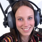 A high resolution photo of an attractive smiling young woman wearing a large helicopter headset, detailed, realistic (3)