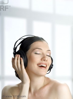 7325997-girl-with-headphones-on-the-blury-background