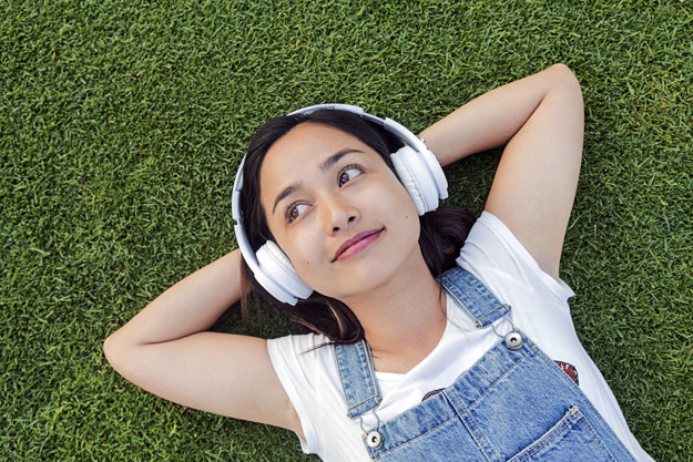 cute-indonesian-girl-with-headphones-laying-on-the-grass_1437-731.jpg