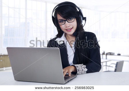 stock-photo-young-beautiful-woman-working-with-laptop-computer-and-headset-in-the-office-256983025.jpg