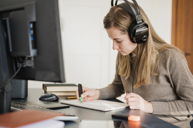 side-view-woman-with-headphones-desk-participating-online-class 23-2148524616